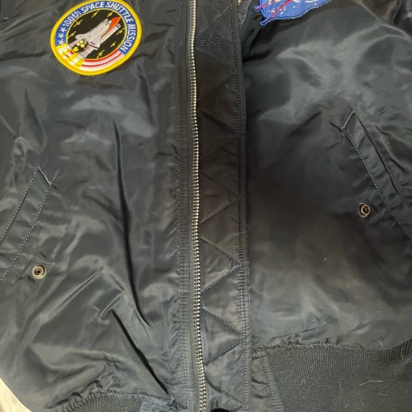 Navy blue bomber jacket With orange inside 
Goes for $300
Flips inside out - Picture 5 of 7
